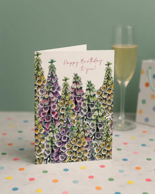 Happy Birthday Foxgloves Greetings Card by Cherith Harrison on Marble Surface