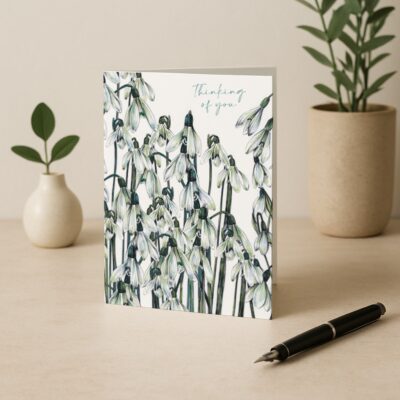 Thinking of You Snowdrops Greetings Card by Cherith Harrison on Neutral Table